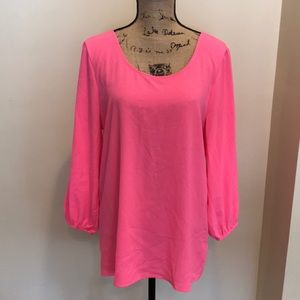 Francesca’s large bright pink blouse